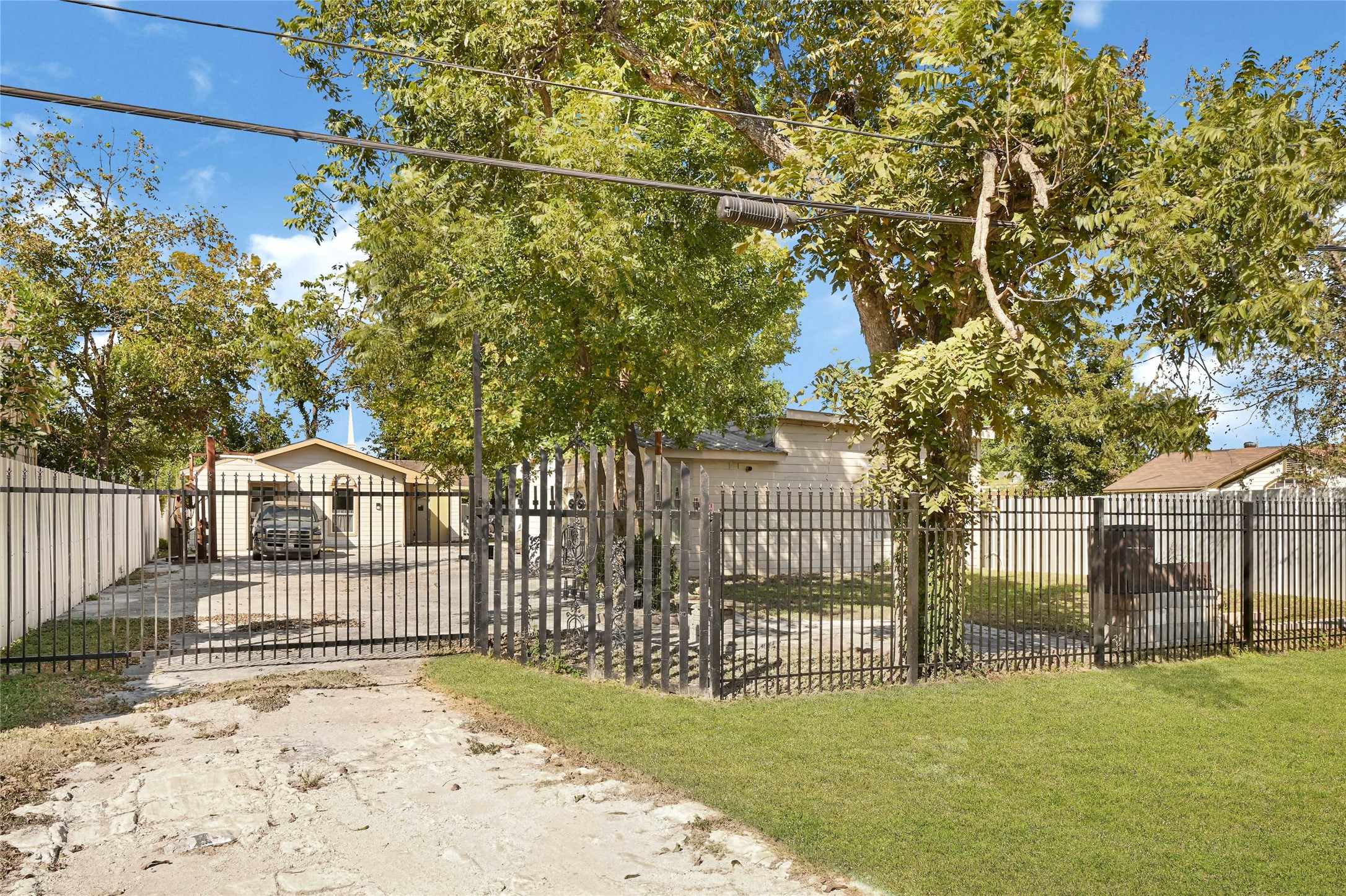 a view of a park with iron fence