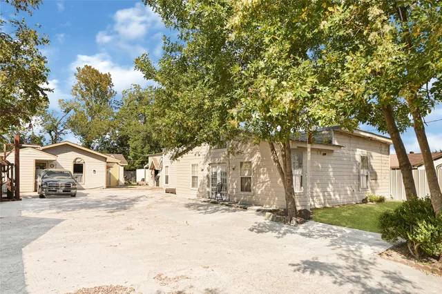 a view of white house with a yard