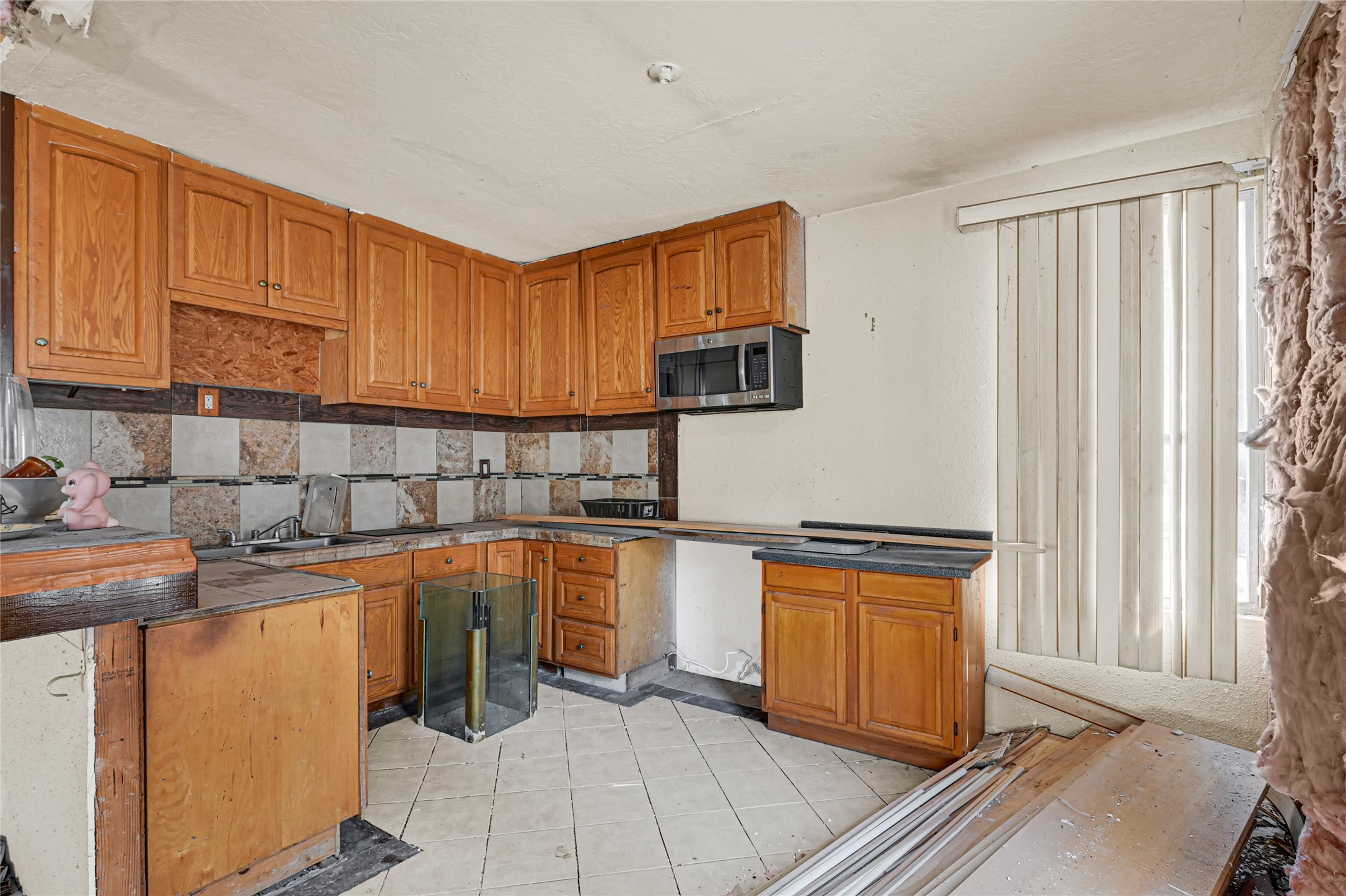 1925 Sunny Drive Houston, TX 77093 - Photo 7 of 24 a kitchen with stainless steel appliances granite countertop a stove a sink and a microwave