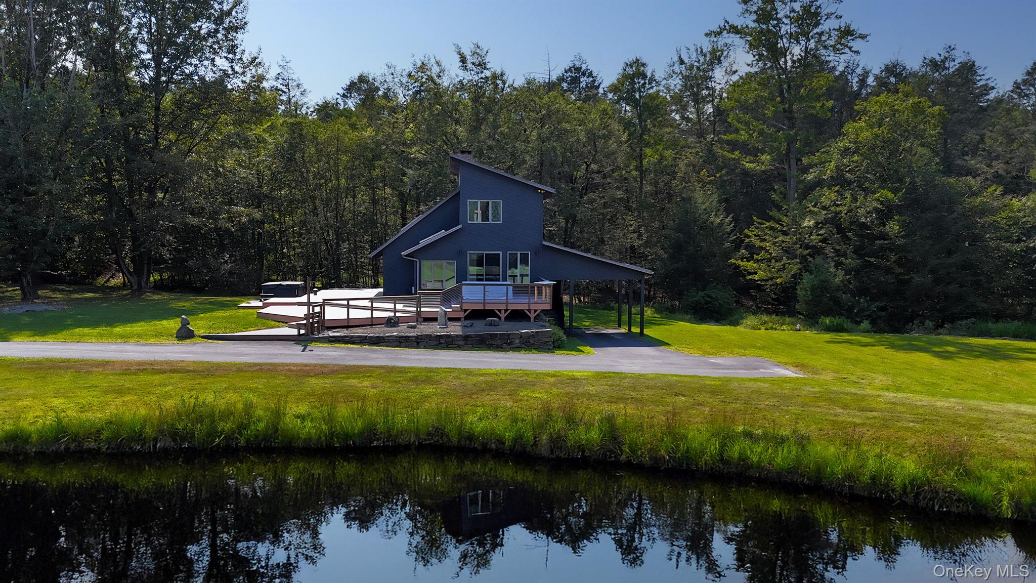 a view of a swimming pool with lawn chairs and plants
