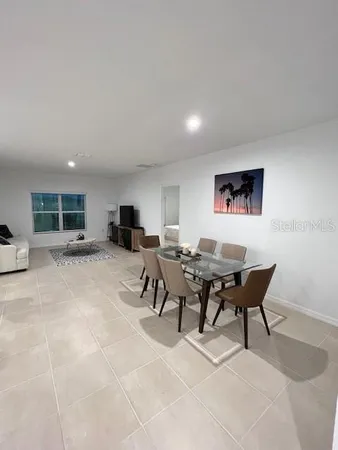 a living room with furniture a rug and a painting