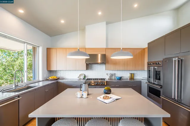 a kitchen with a sink a counter top space and stainless steel appliances