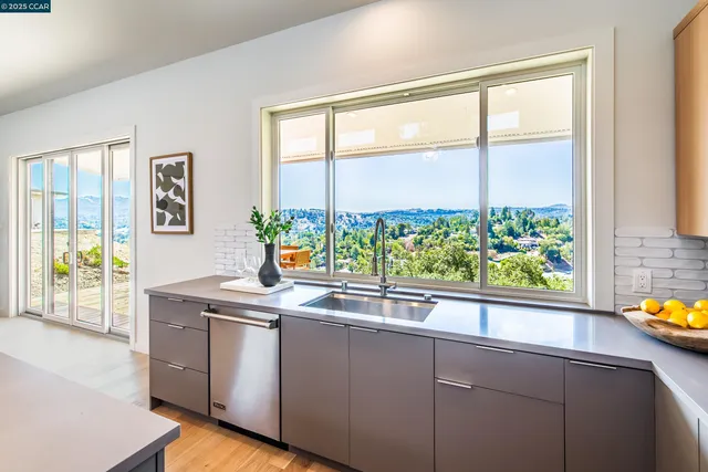 a kitchen with granite countertop a stove and a sink
