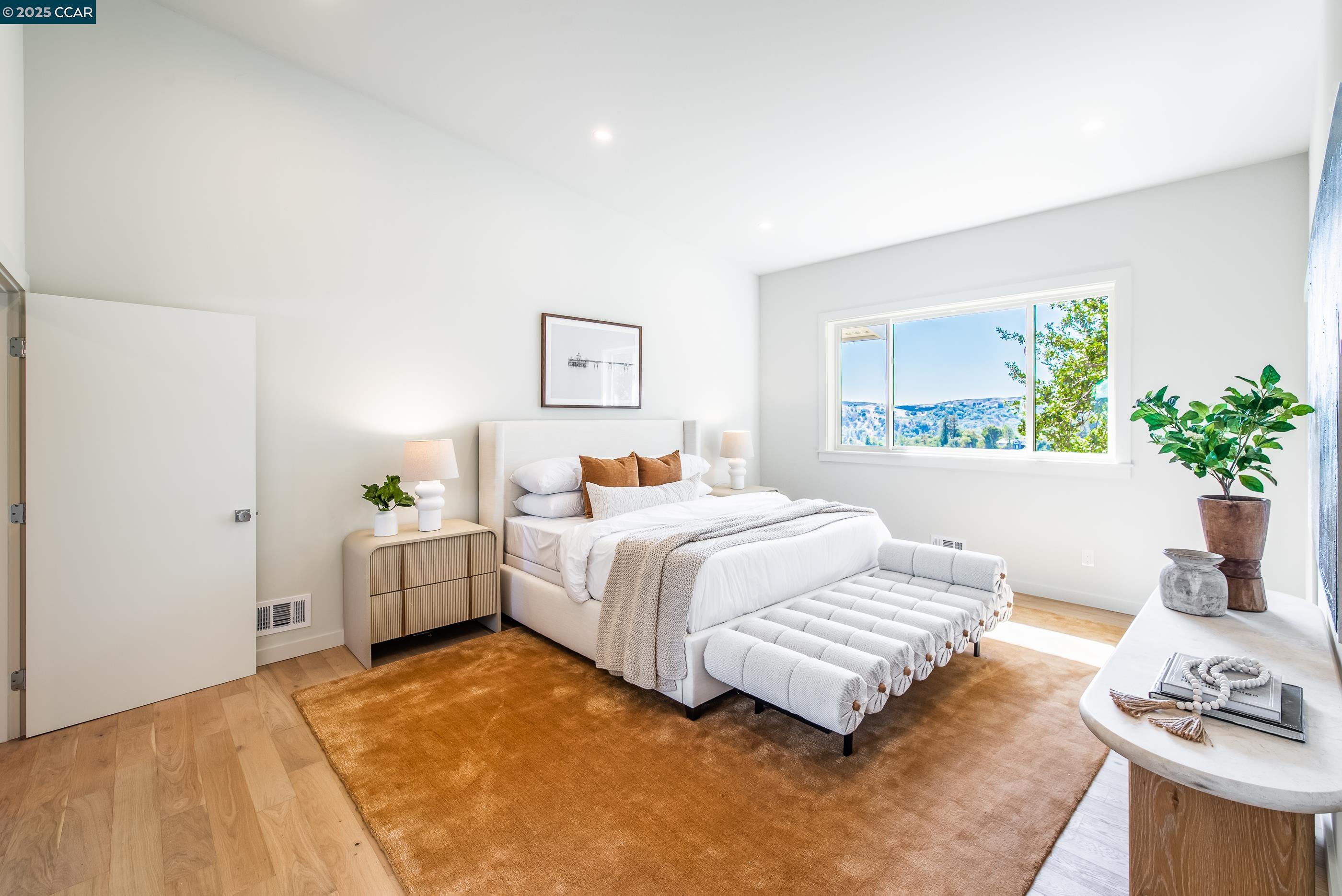 105 Hillcroft Way Walnut Creek, CA 94597 - Photo 29 of 56 a bedroom with bed and a potted plant