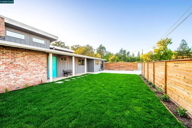 a view of a house with a yard and a garden