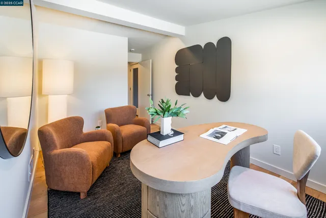 a view of a patio with table and chairs and floor to ceiling window with wooden floor