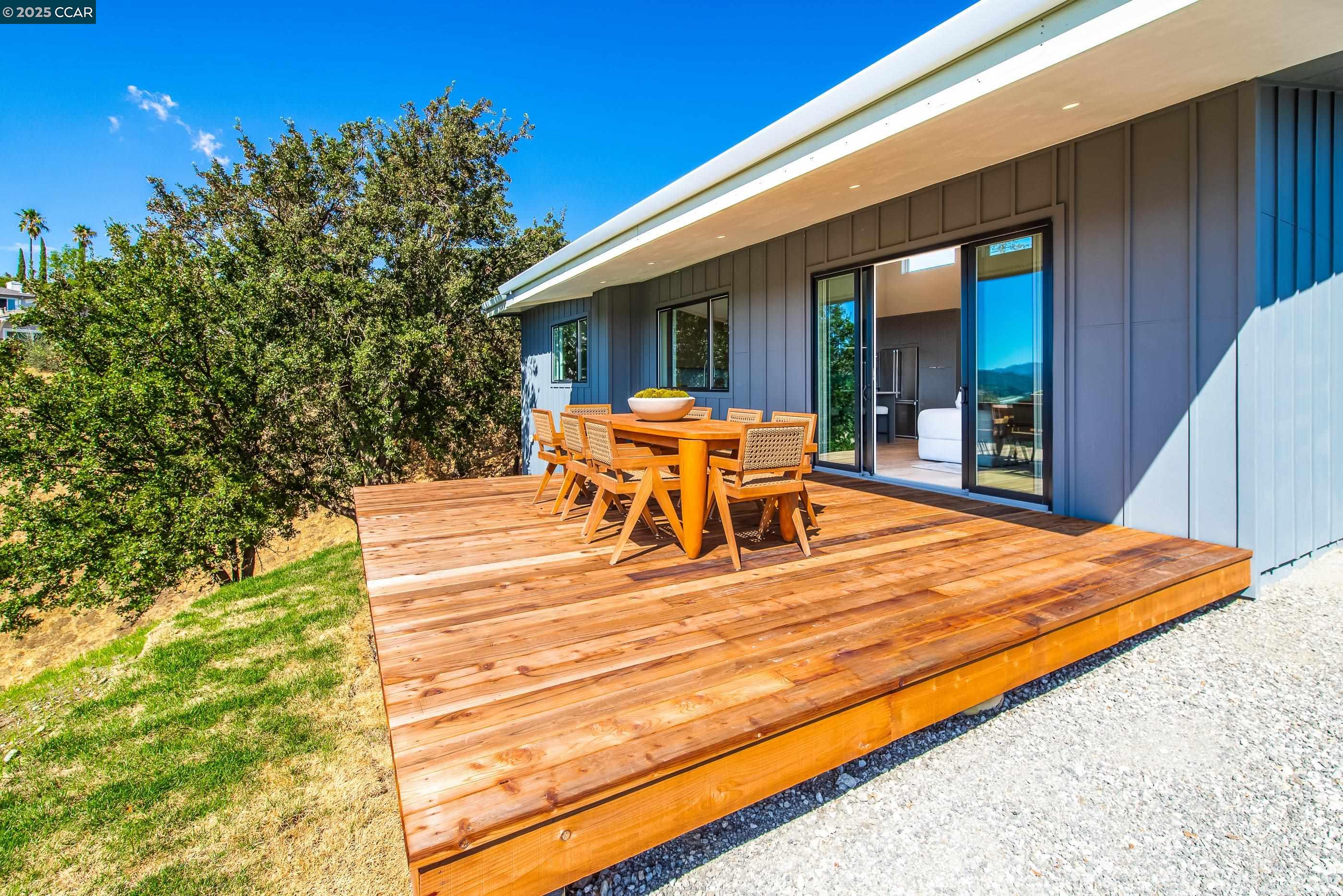 105 Hillcroft Way Walnut Creek, CA 94597 - Photo 39 of 56 a view of a patio with table and chairs and floor to ceiling window with wooden floor
