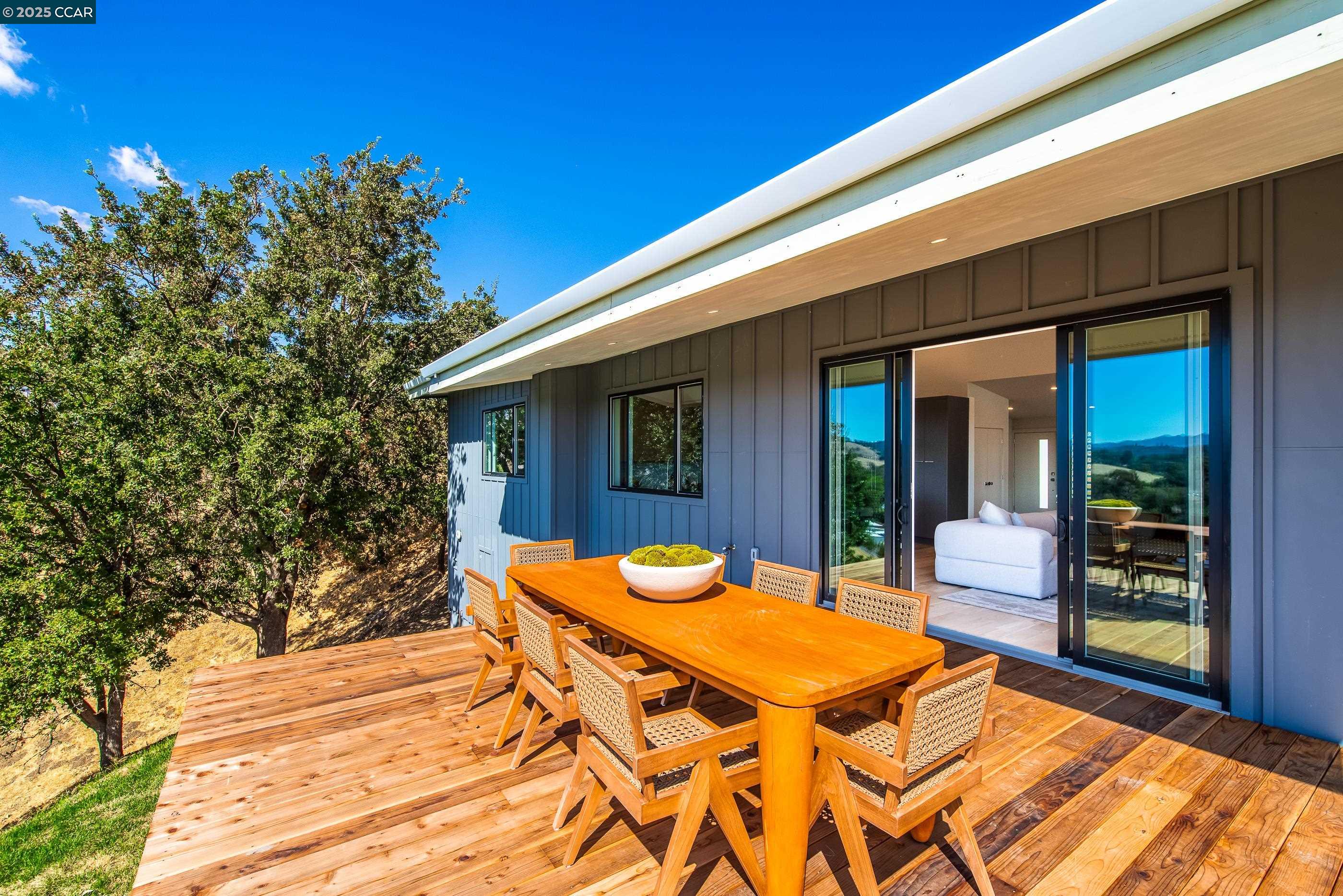 105 Hillcroft Way Walnut Creek, CA 94597 - Photo 40 of 56 a view of a patio with table and chairs with wooden floor and fence
