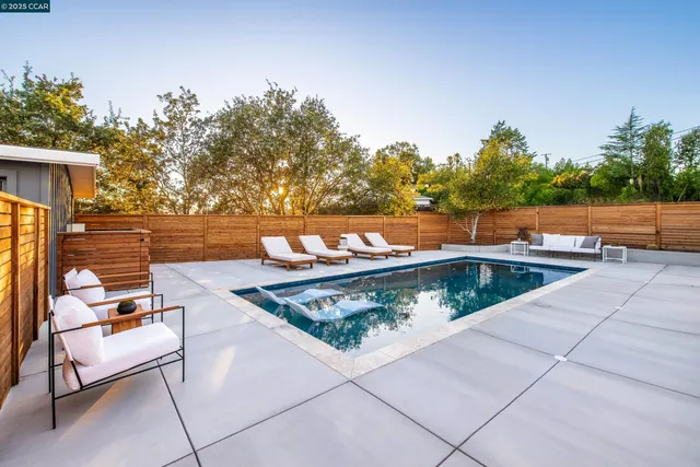 a view of swimming pool with lounge chair