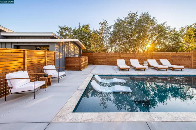 a backyard of a house with table and chairs