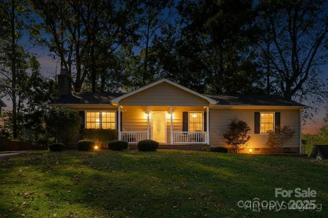 a front view of a house with a yard and outdoor seating