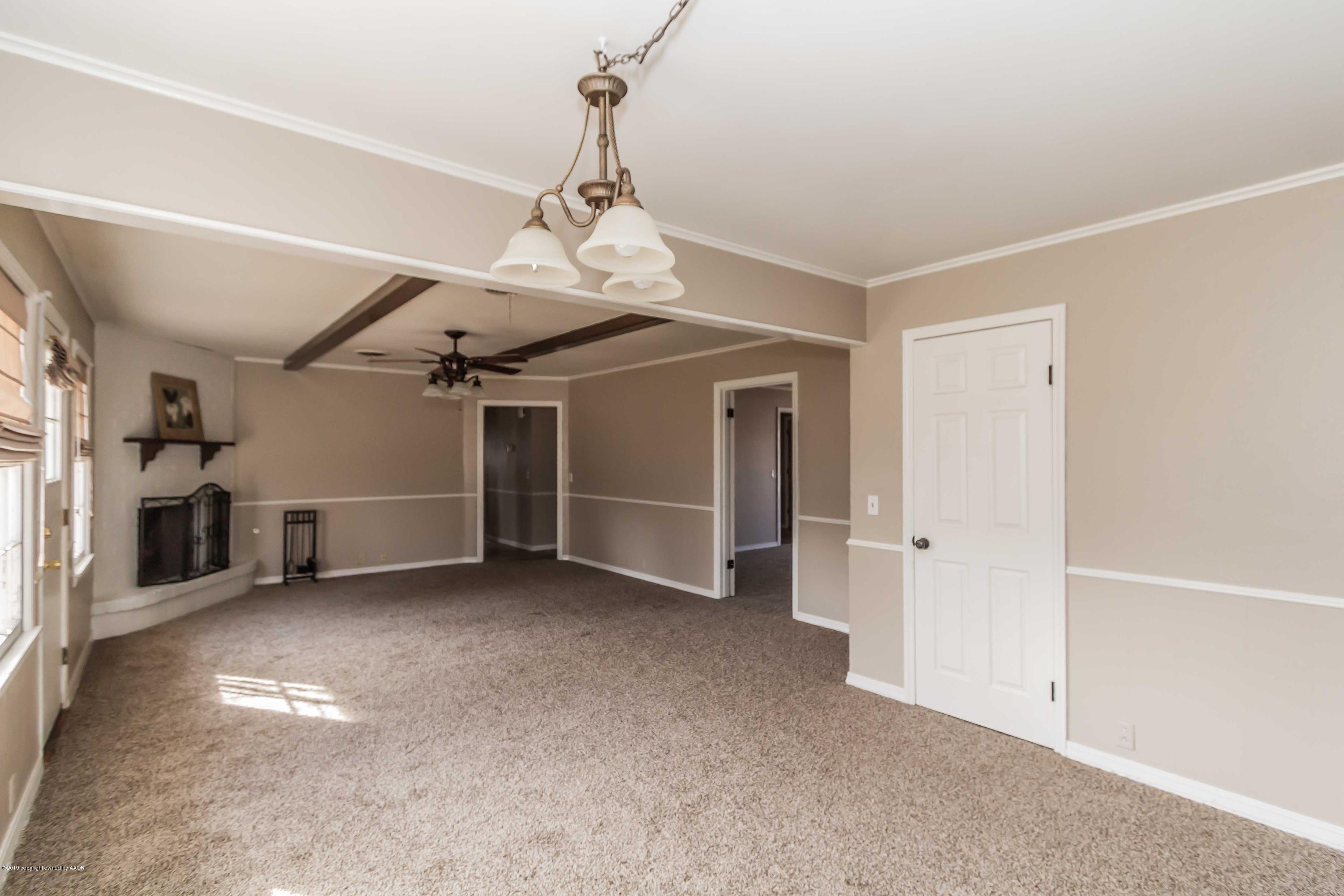 6205 Calumet Road Amarillo, TX 79106 - Photo 17 of 39 a view of a livingroom with a chandelier