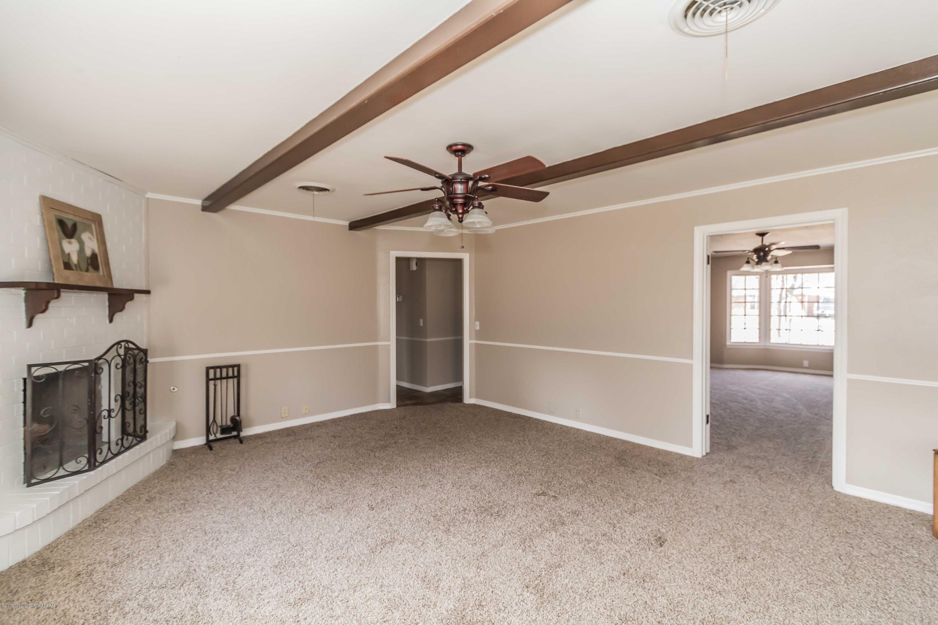 6205 Calumet Road Amarillo, TX 79106 - Photo 20 of 39 a view of a livingroom with a ceiling fan and window
