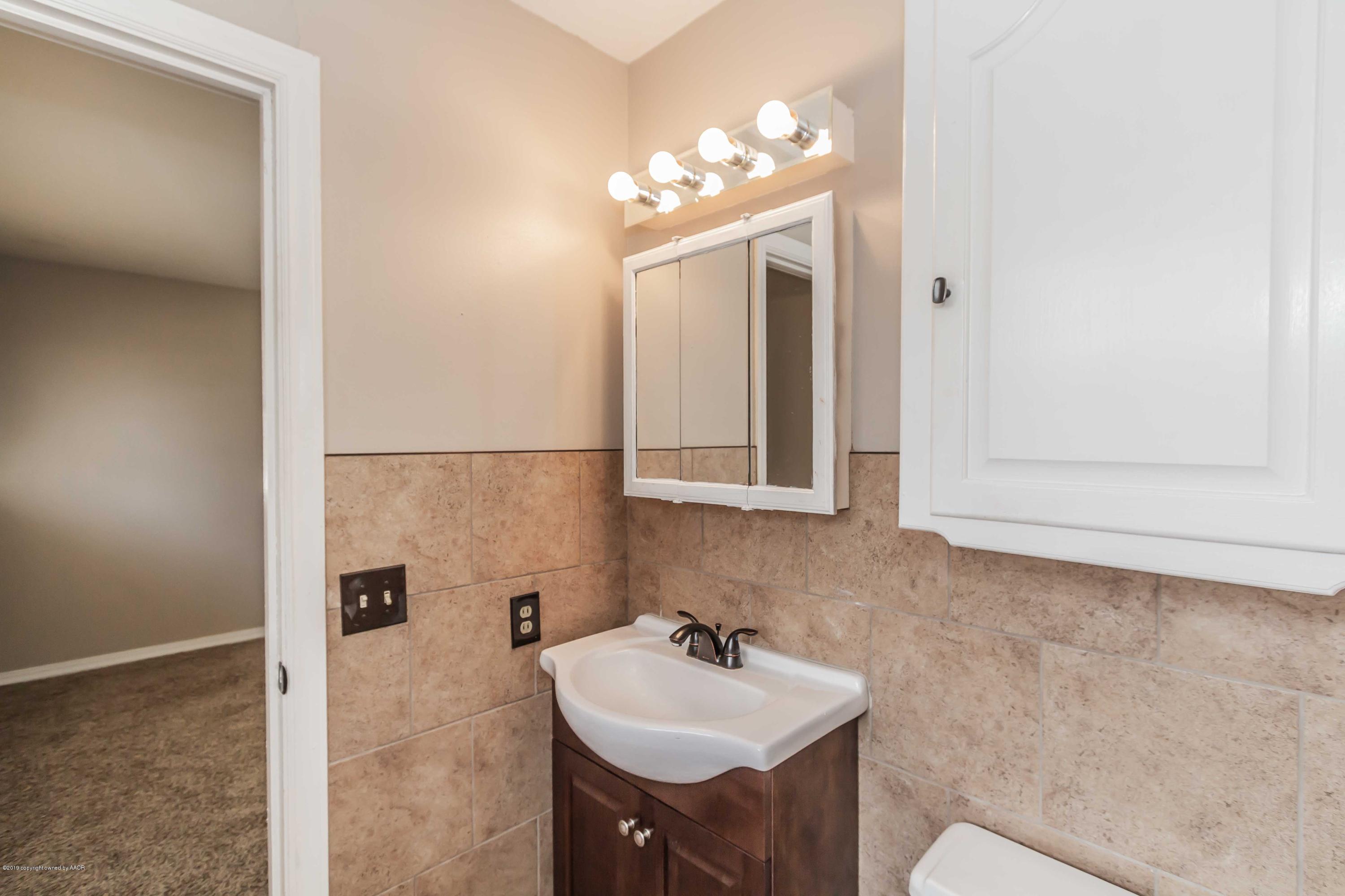 6205 Calumet Road Amarillo, TX 79106 - Photo 26 of 39 a bathroom with a sink and a mirror