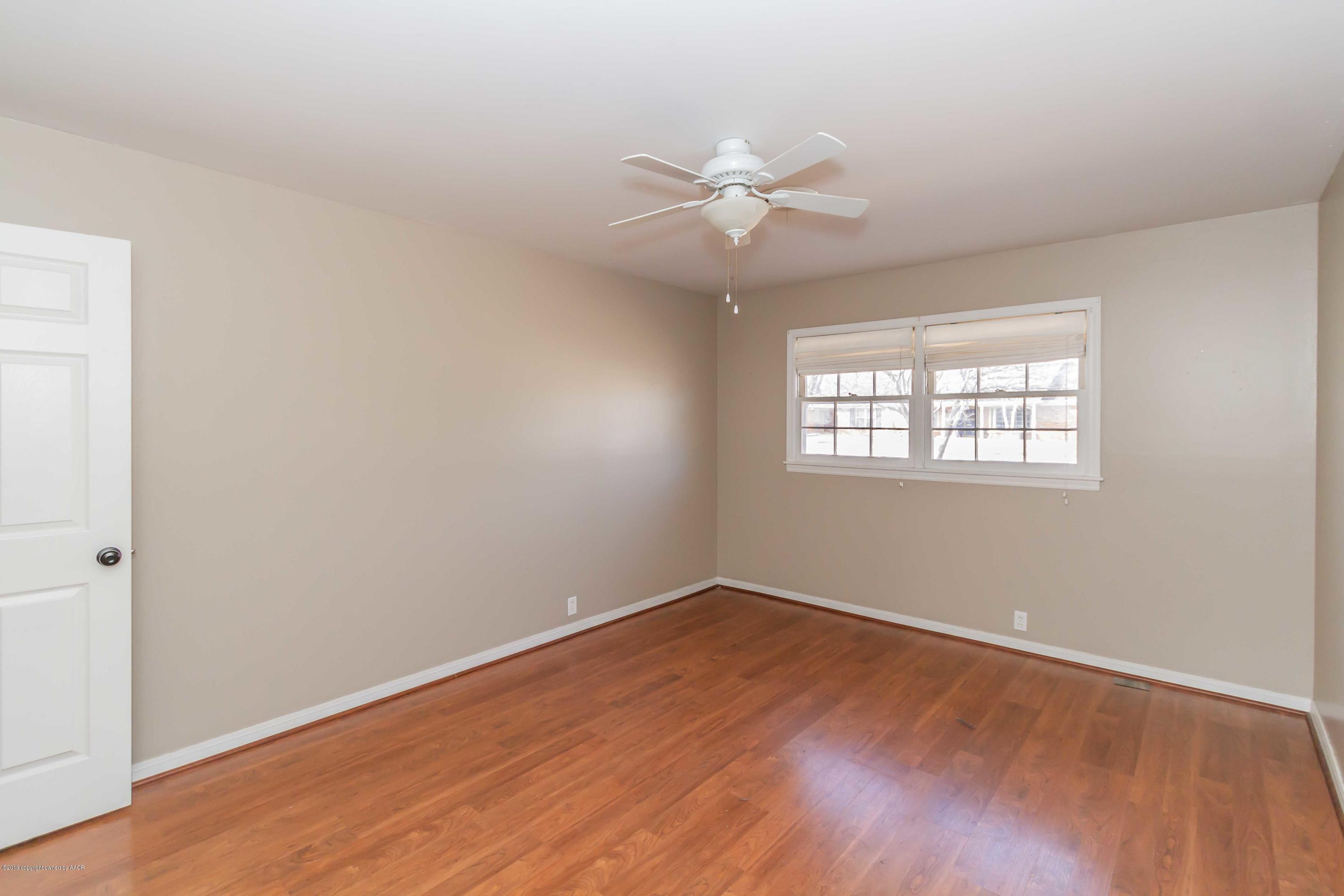 6205 Calumet Road Amarillo, TX 79106 - Photo 27 of 39 wooden floor in an empty room with a window