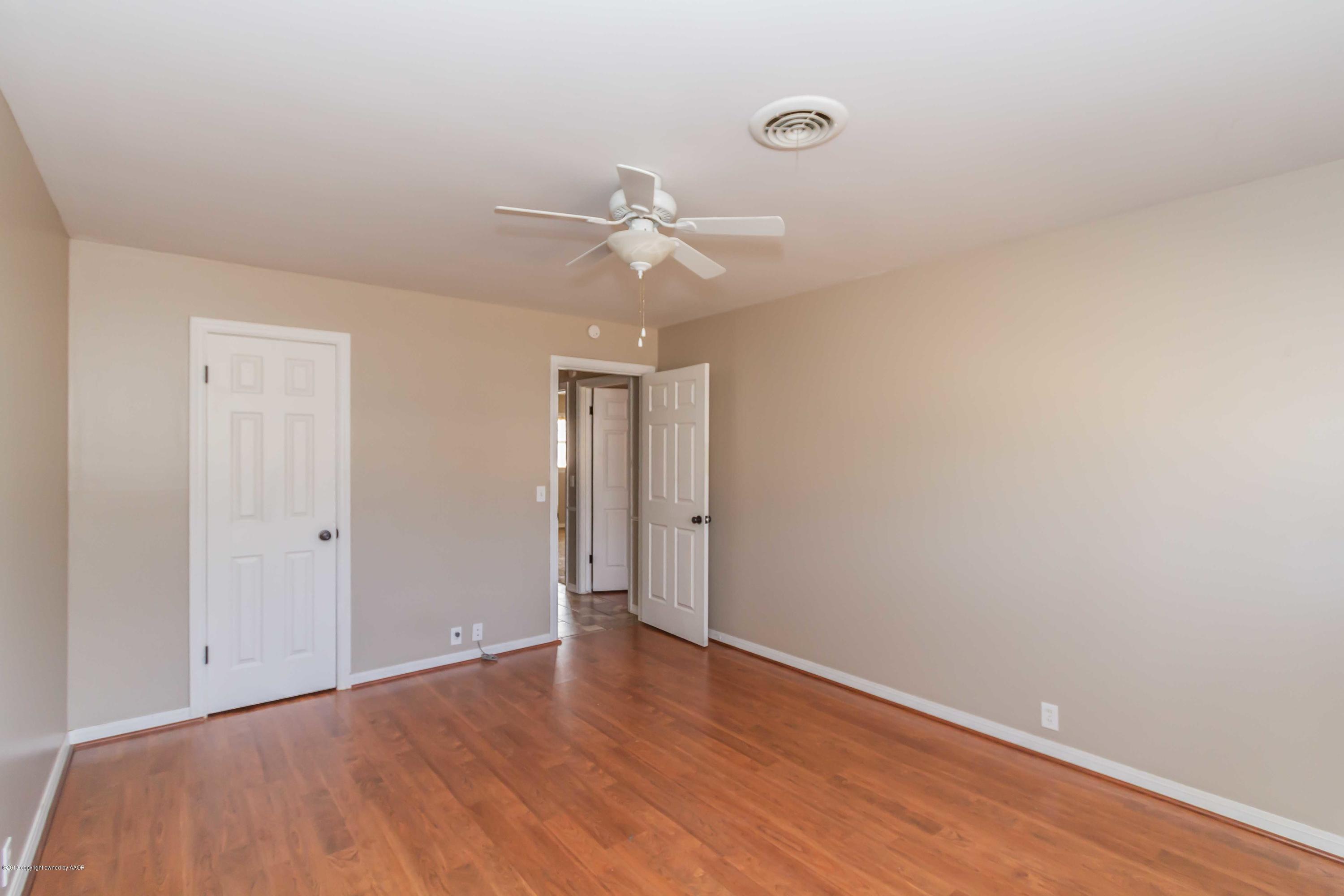 6205 Calumet Road Amarillo, TX 79106 - Photo 28 of 39 a view of a room with wooden floor and a ceiling fan