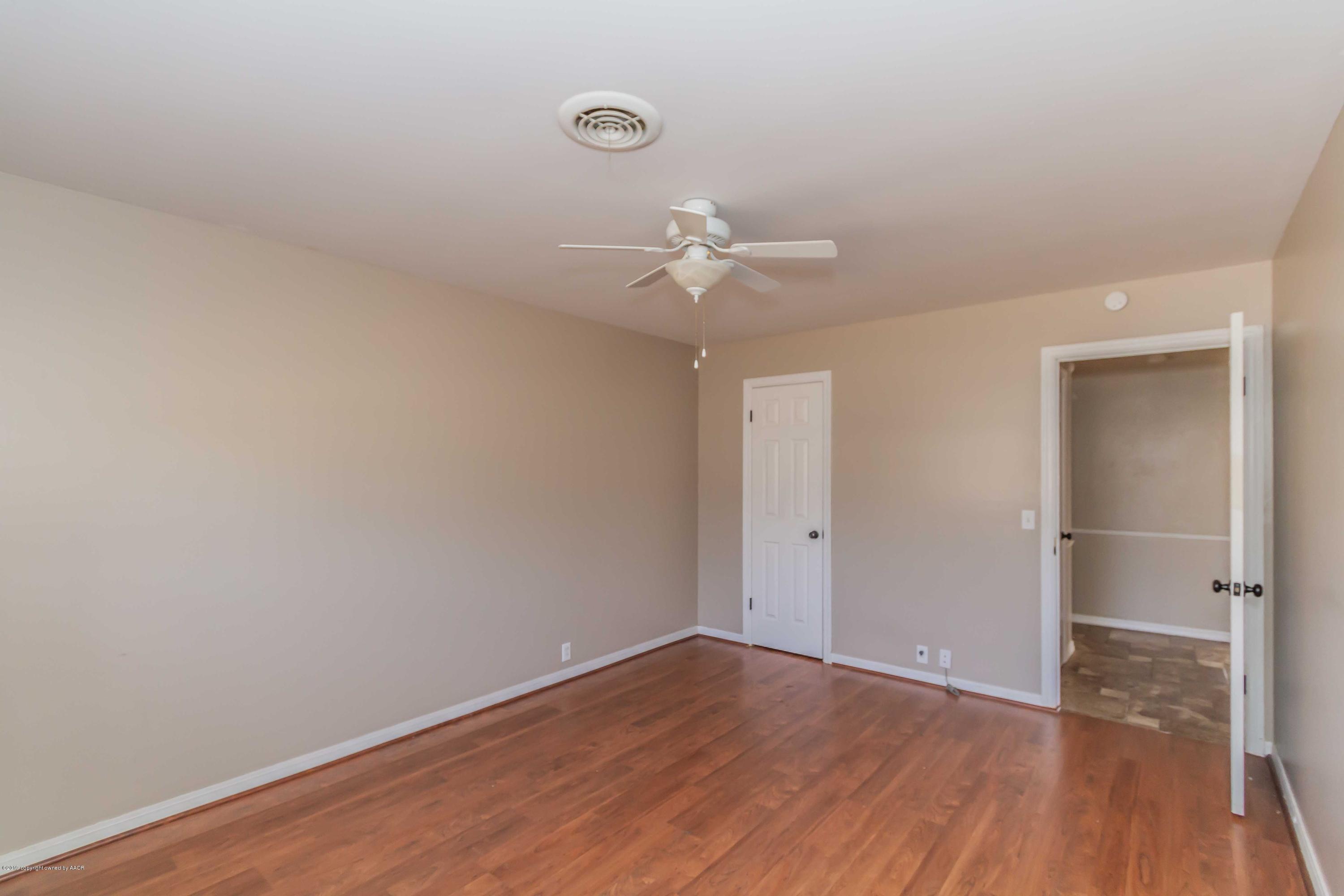 6205 Calumet Road Amarillo, TX 79106 - Photo 29 of 39 an empty room with wooden floor and fan