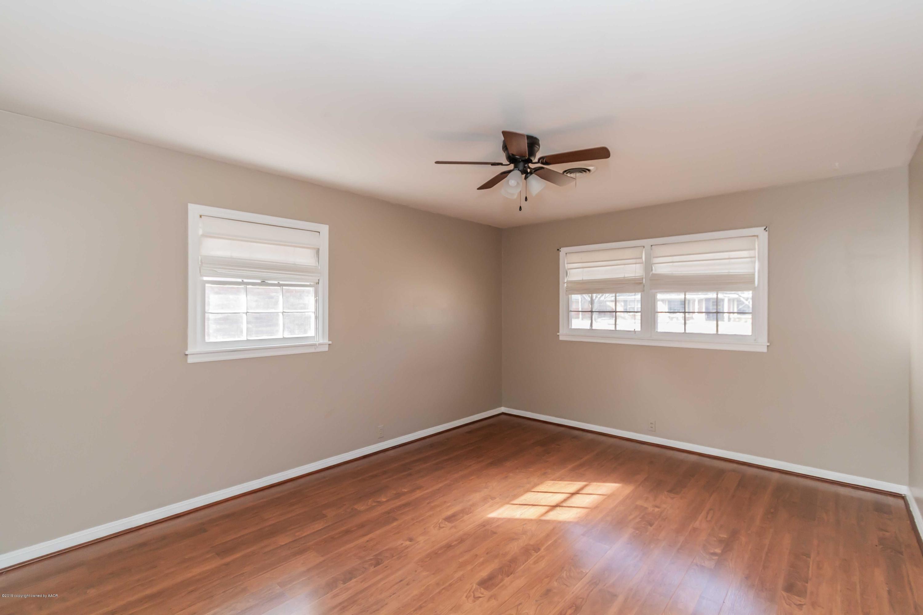 6205 Calumet Road Amarillo, TX 79106 - Photo 30 of 39 a view of a big room with wooden floor and windows