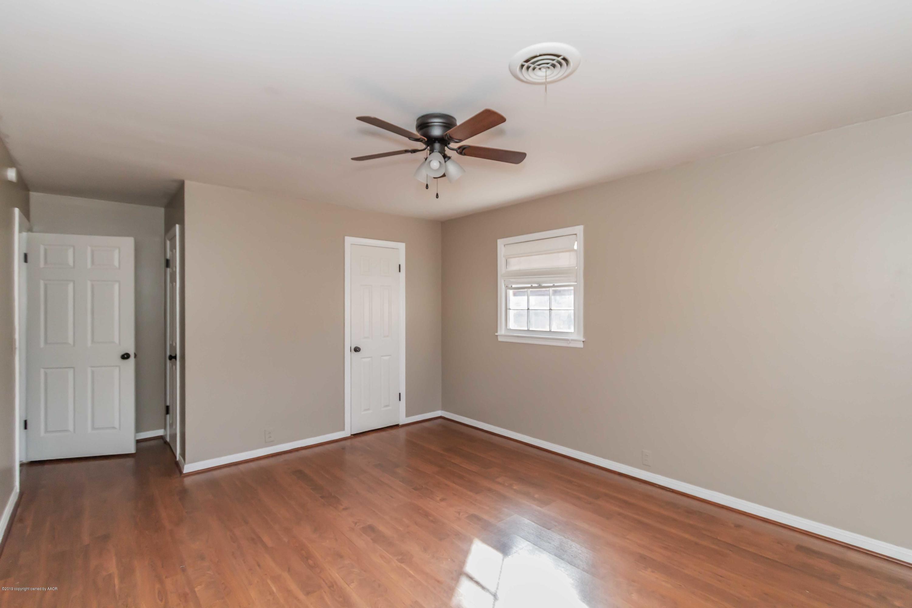 6205 Calumet Road Amarillo, TX 79106 - Photo 31 of 39 a view of a room with wooden floor and a ceiling fan