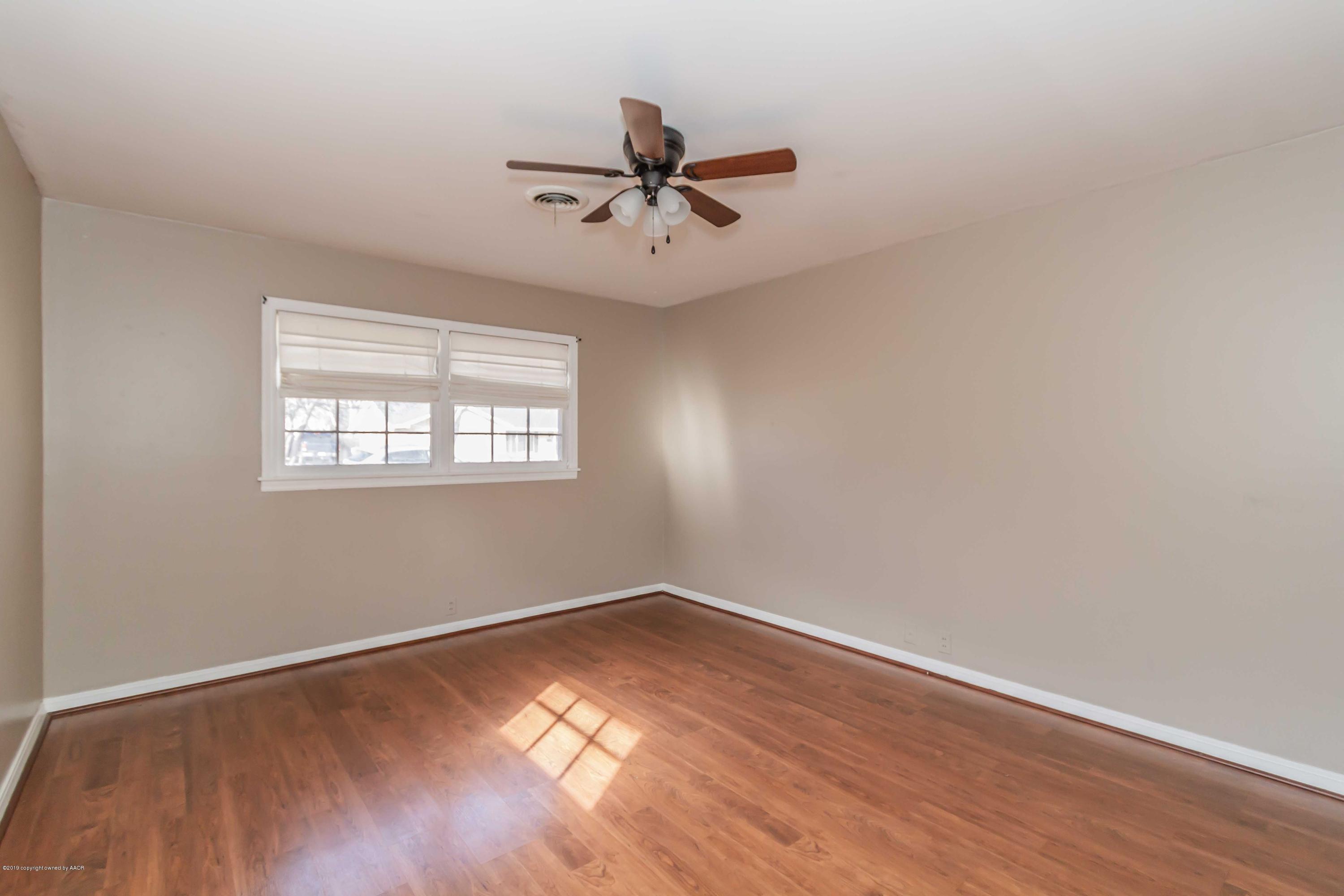 6205 Calumet Road Amarillo, TX 79106 - Photo 33 of 39 an empty room with wooden floor fan and windows
