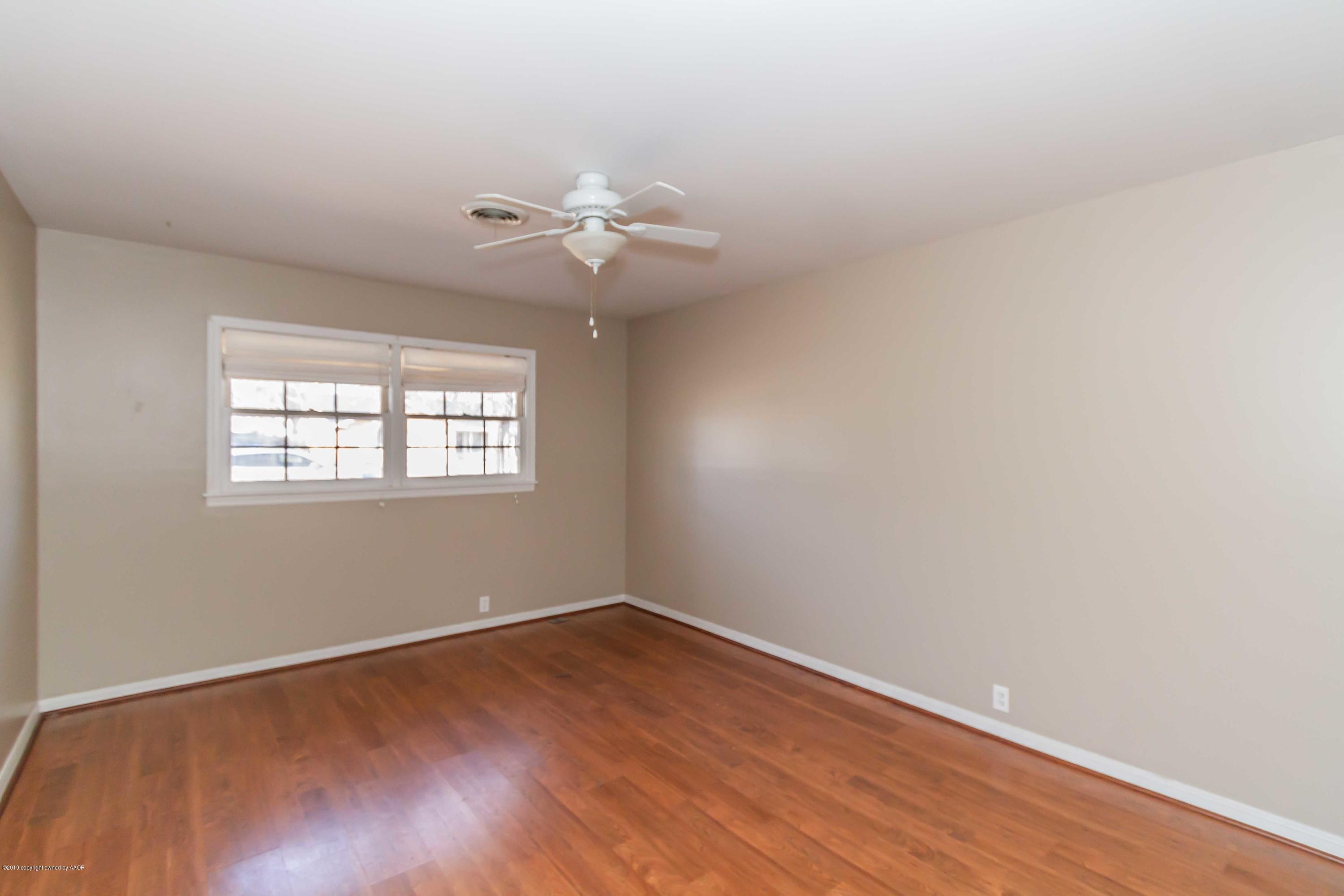 6205 Calumet Road Amarillo, TX 79106 - Photo 8 of 39 wooden floor in an empty room with a window