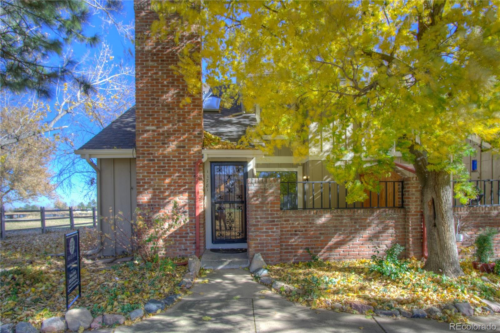11781 West Elk Head Range Road Littleton, CO 80127 - Photo 1 of 48 a front view of a house with a yard