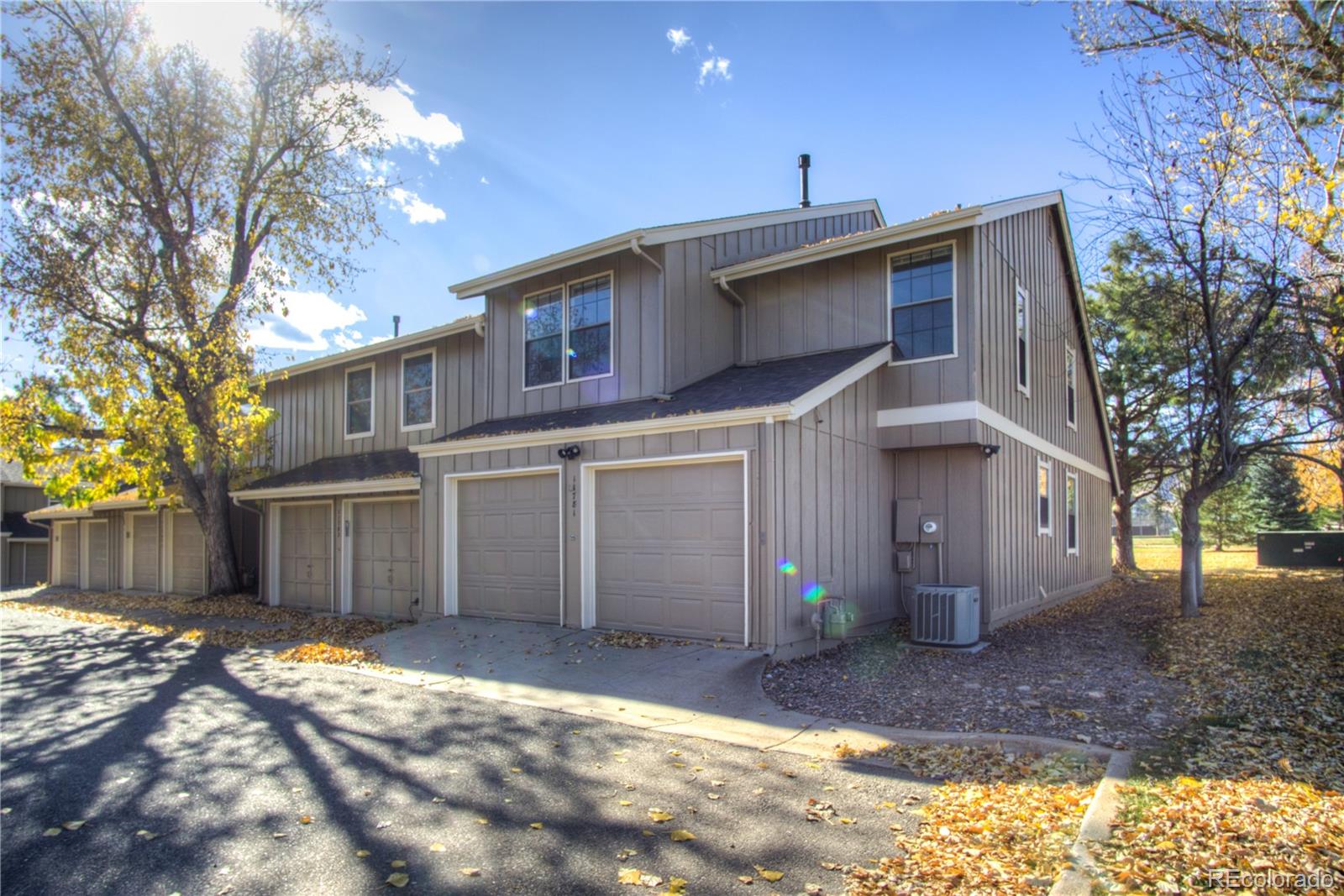 11781 West Elk Head Range Road Littleton, CO 80127 - Photo 2 of 48 a front view of a house with a yard and garage