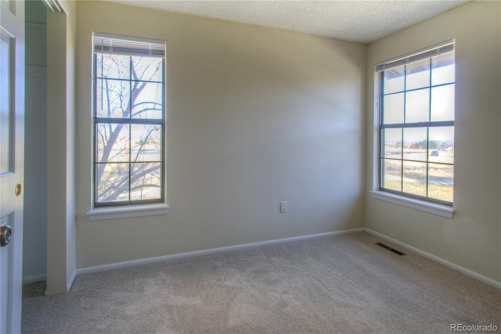 11781 West Elk Head Range Road Littleton, CO 80127 - Photo 23 of 48 an empty room with windows