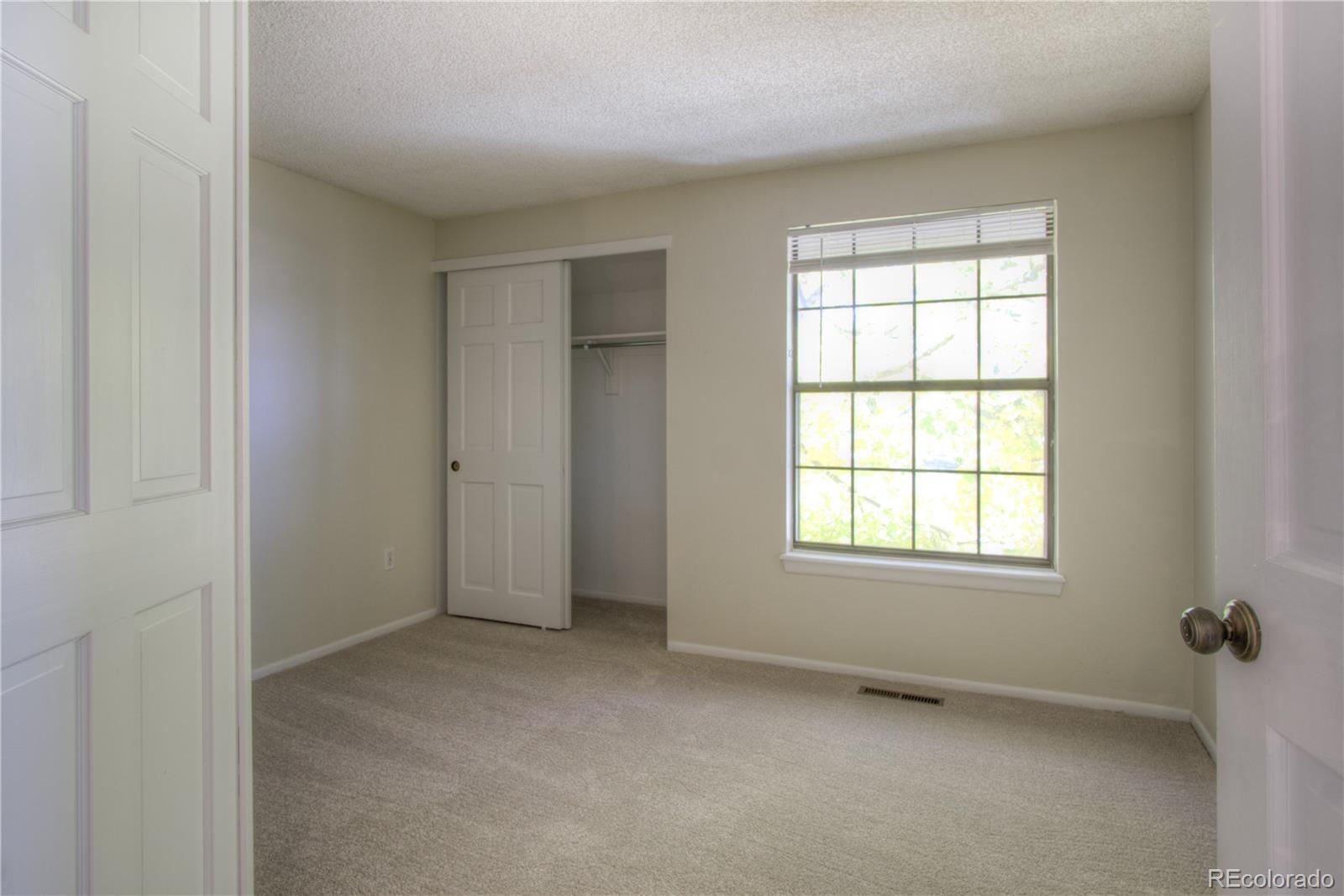 11781 West Elk Head Range Road Littleton, CO 80127 - Photo 25 of 48 an empty room with windows