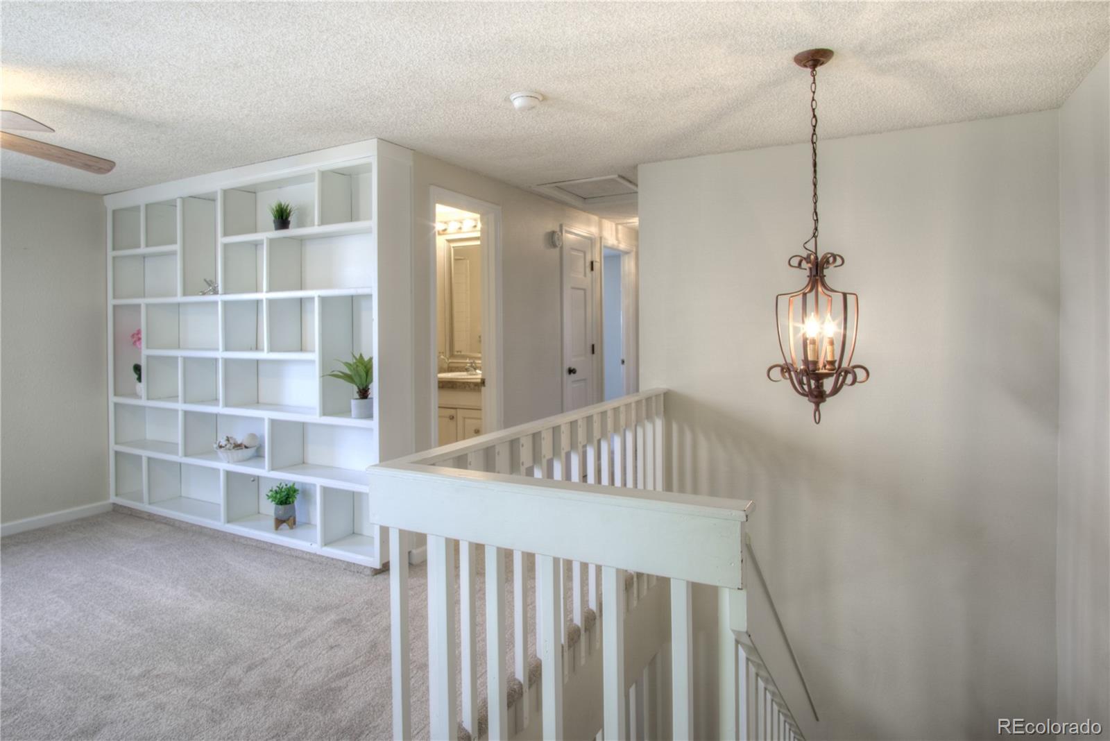 11781 West Elk Head Range Road Littleton, CO 80127 - Photo 26 of 48 a view of a livingroom with furniture and staircase