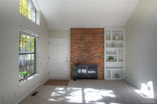 a view of empty room with a fireplace