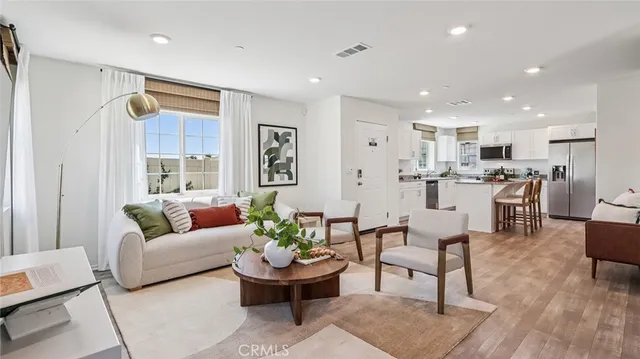 a living room with furniture and view of kitchen