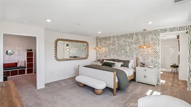 a spacious bedroom with a bed and a window