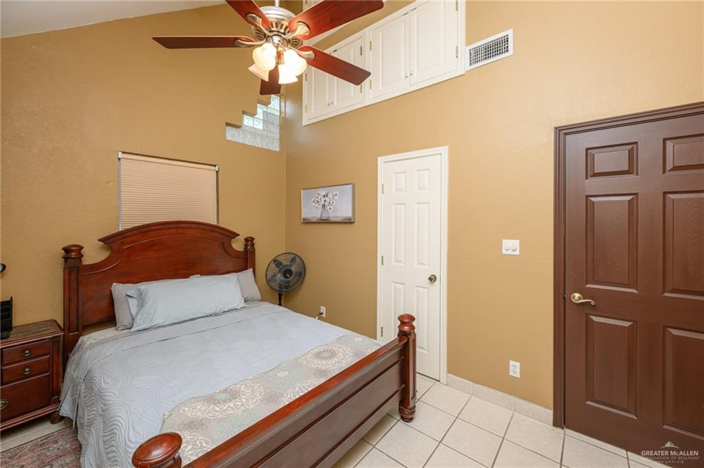 36431 Marshall Hutts Road Rio Hondo, TX 78583 - Photo 17 of 45 a bedroom with a bed and a chandelier