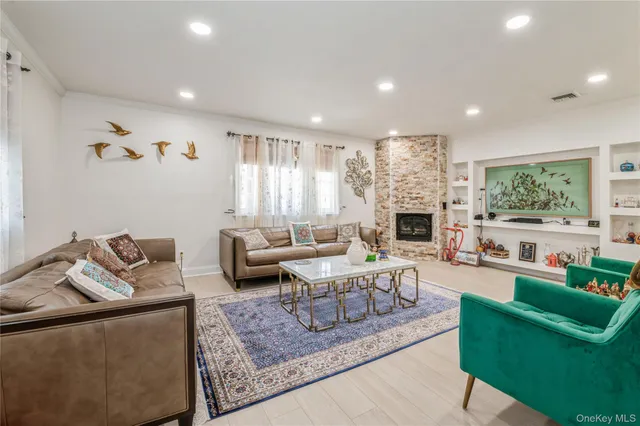 a living room with furniture fireplace and a large window