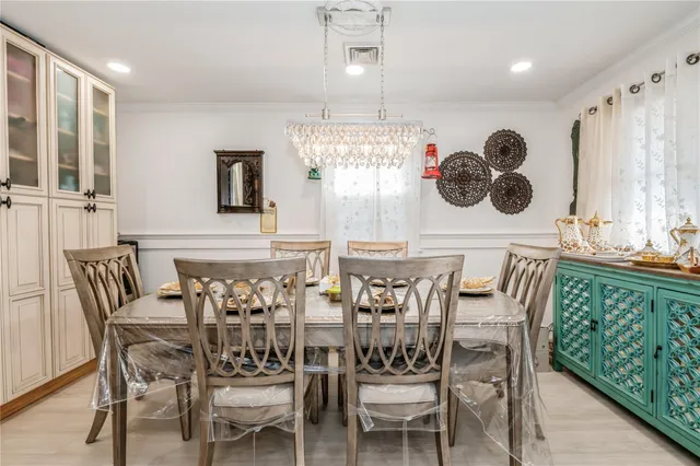 a view of a dining room with furniture and chandelier