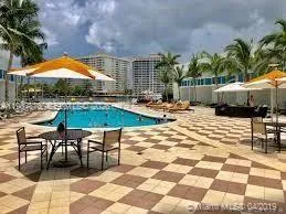 a view of swimming pool with outdoor seating