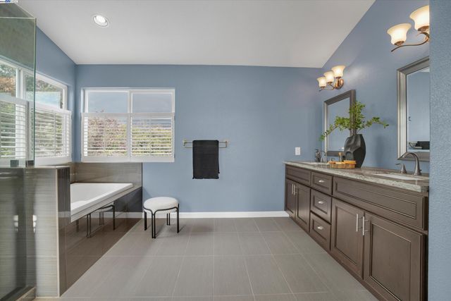 a spacious bathroom with a double vanity sink and a mirror