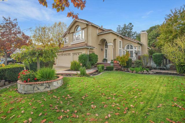 a front view of a house with a yard table and chairs