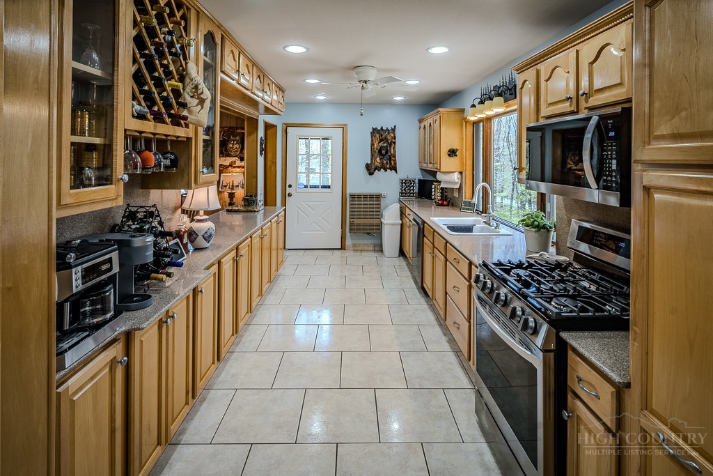 103-105 Upper Grouse Ridge Road Beech Mountain, NC 28604 - Photo 8 of 48 a large kitchen with stainless steel appliances a sink and a stove