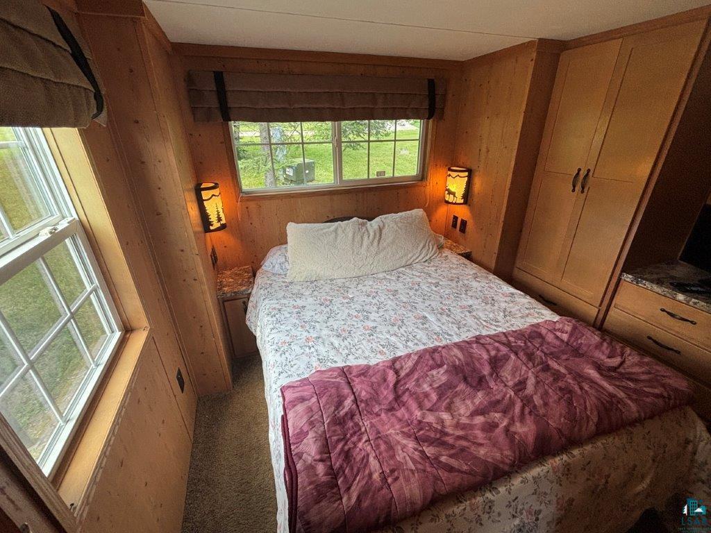 9436 Bear Ridge Drive Orr, MN 55771 - Photo 10 of 26 Carpeted bedroom featuring wooden walls
