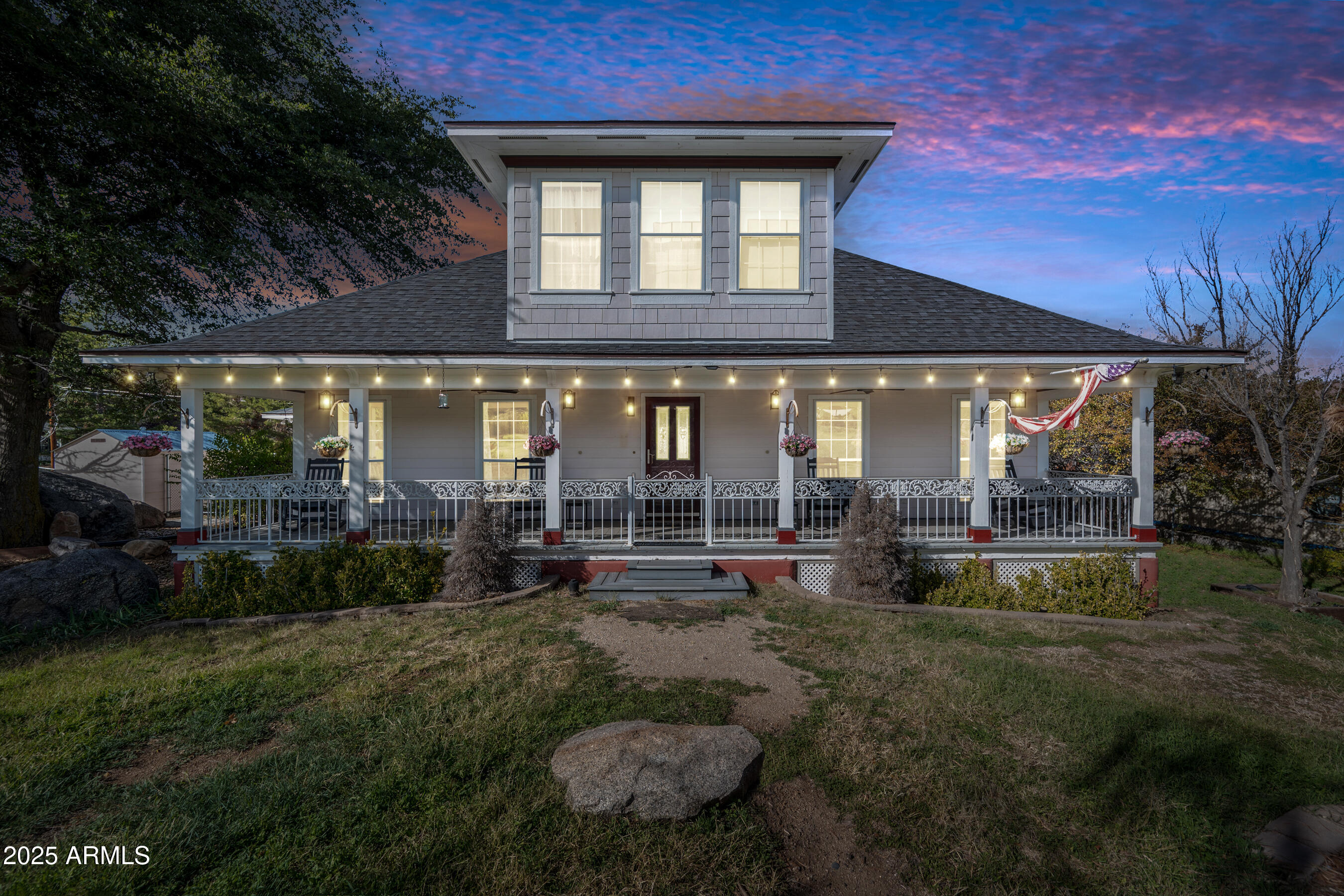 a view of a house with backyard and sitting area