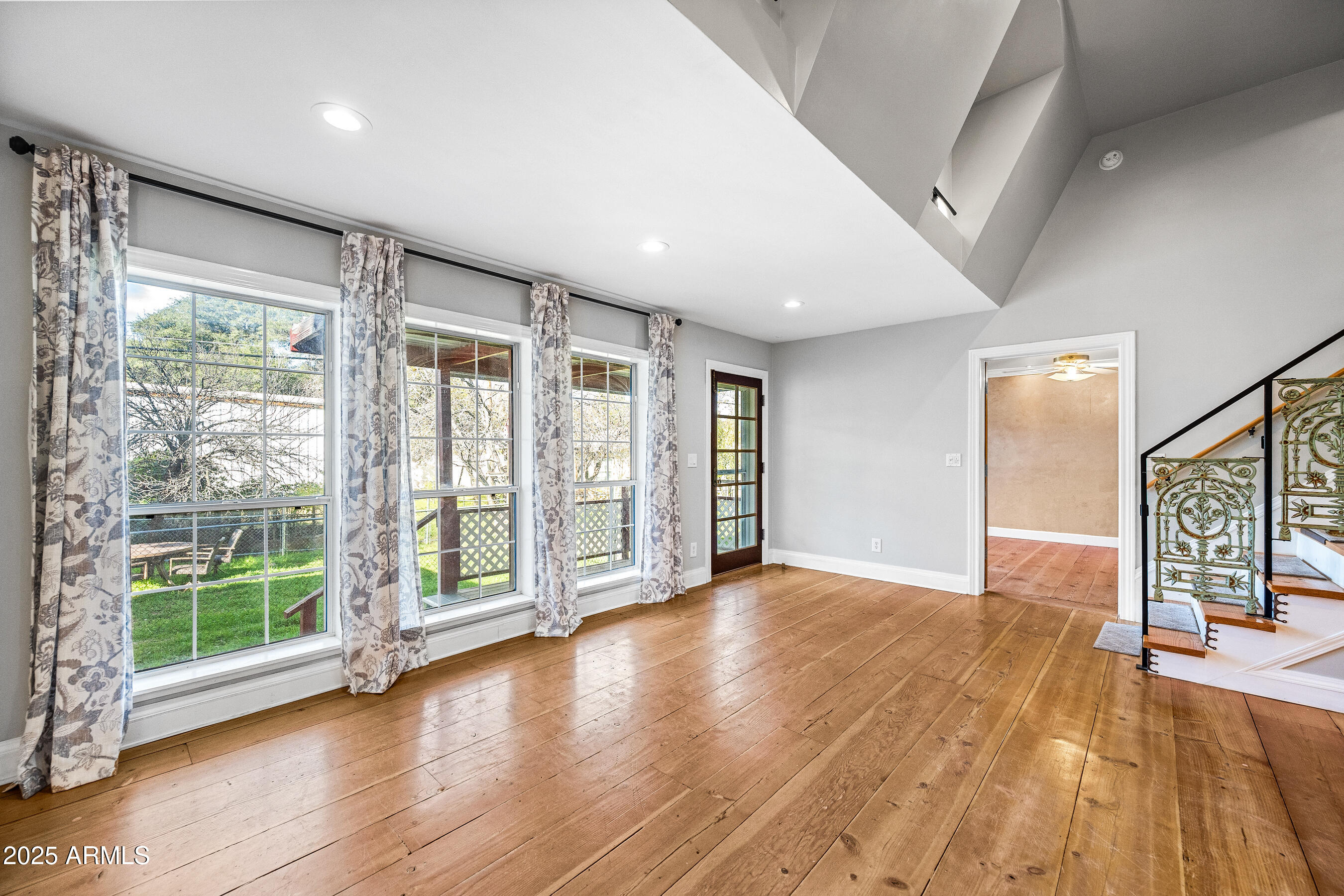 17288 Foothill Road Yarnell, AZ 85362 - Photo 11 of 79 a view of an empty room with wooden floor and a window