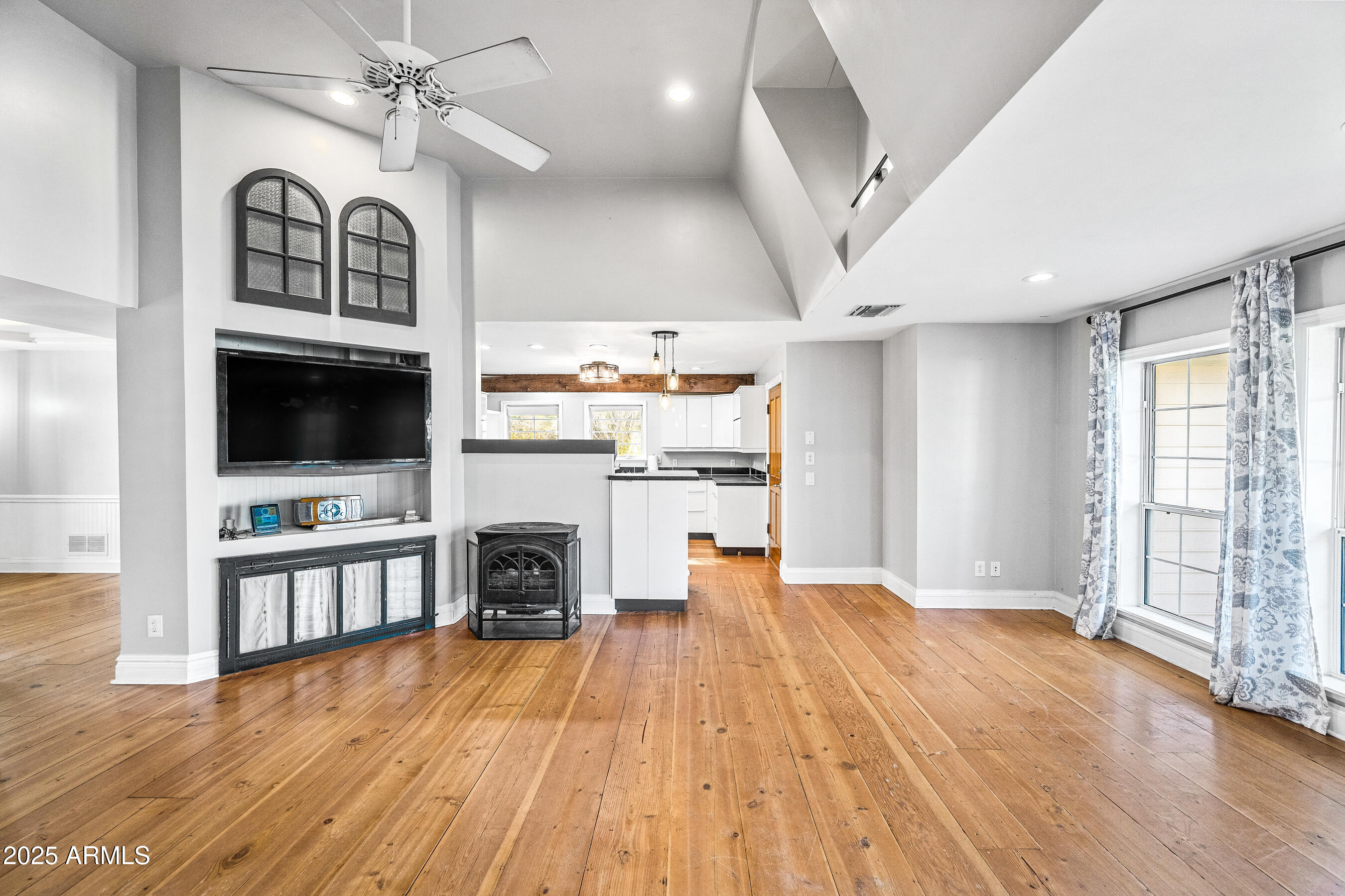 17288 Foothill Road Yarnell, AZ 85362 - Photo 12 of 79 a view of a livingroom with a kitchen and a ceiling fan wooden floor
