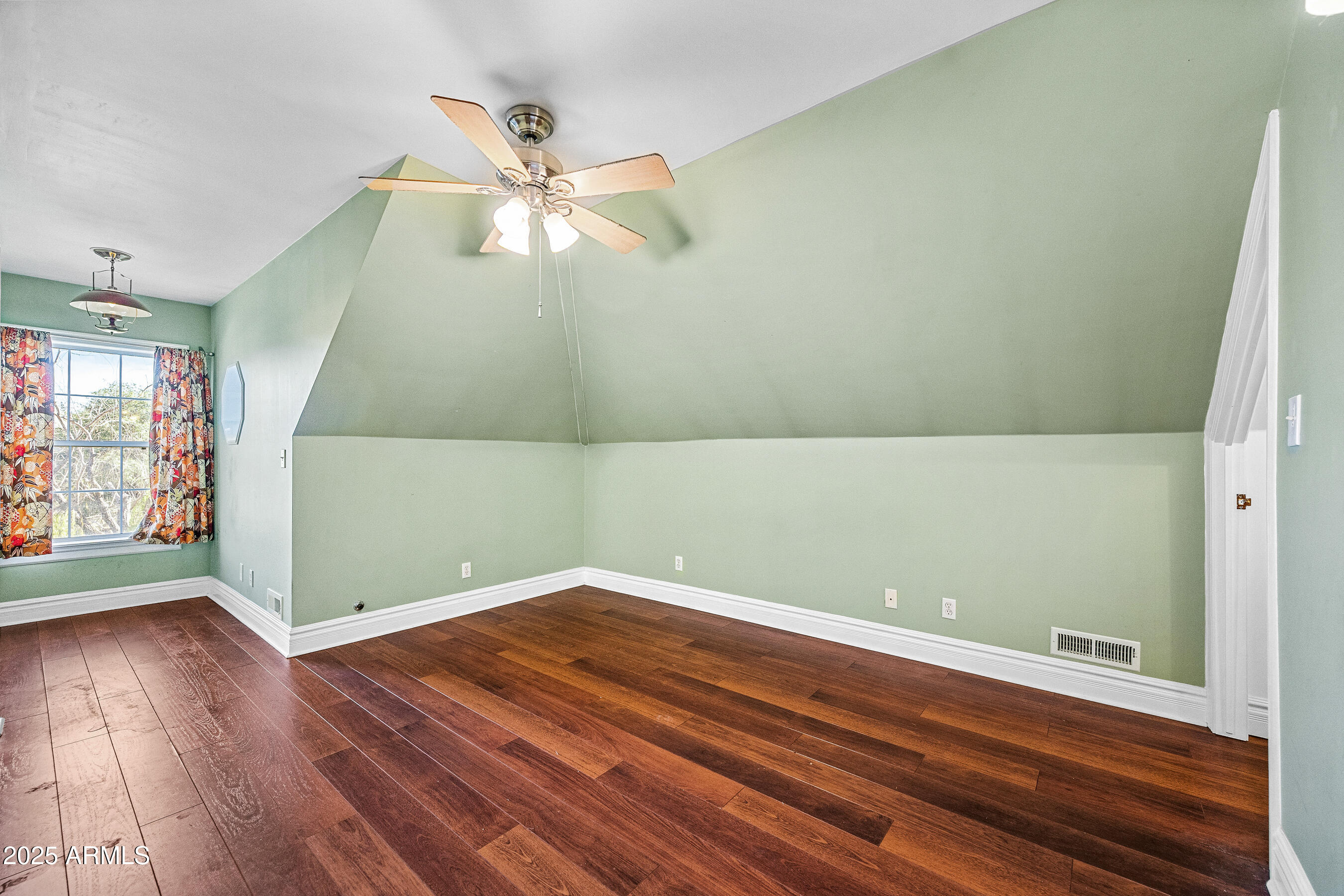 17288 Foothill Road Yarnell, AZ 85362 - Photo 48 of 79 an empty room with wooden floor fan and windows