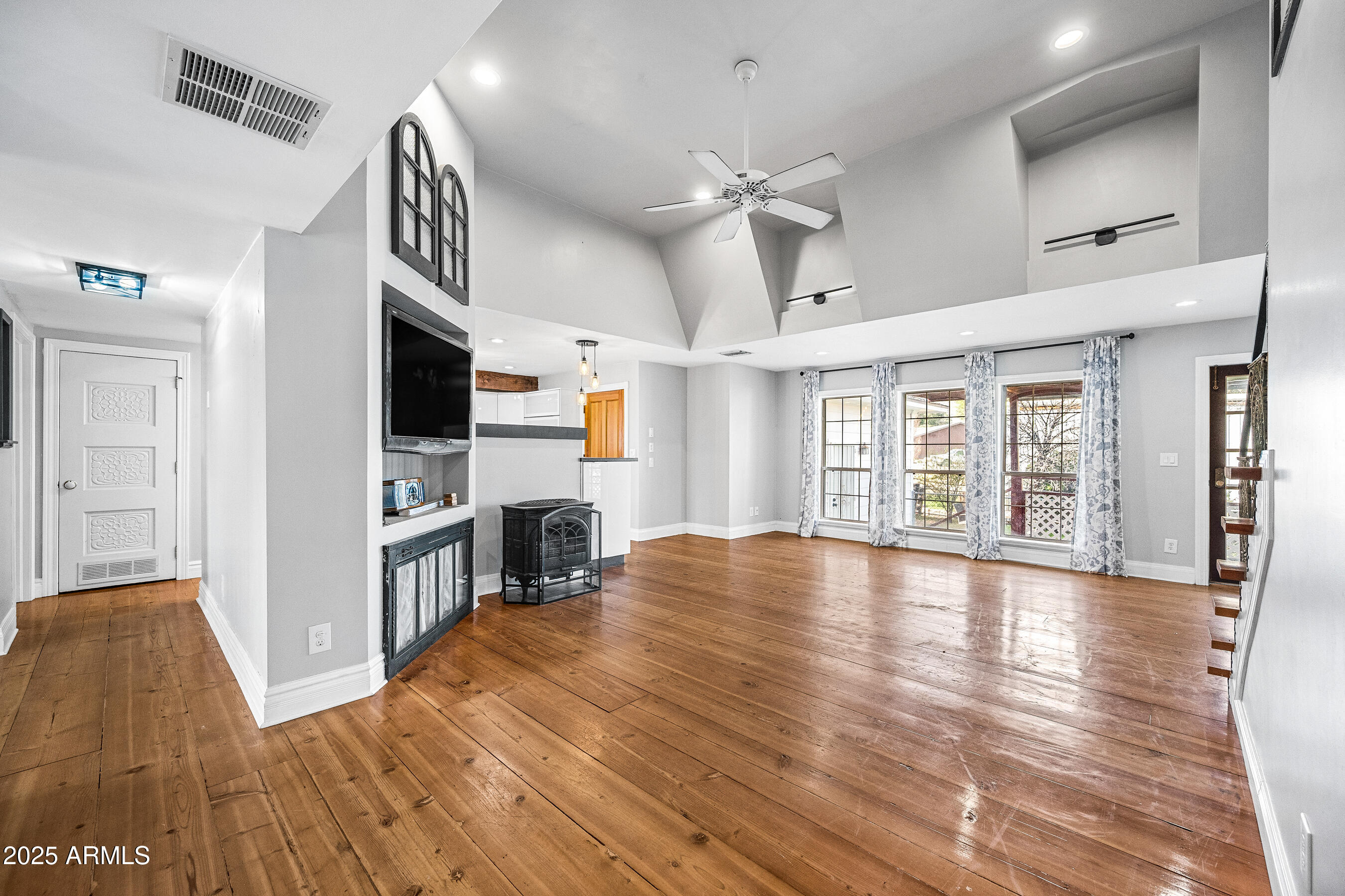 17288 Foothill Road Yarnell, AZ 85362 - Photo 7 of 79 a view of empty room with wooden floor and fireplace