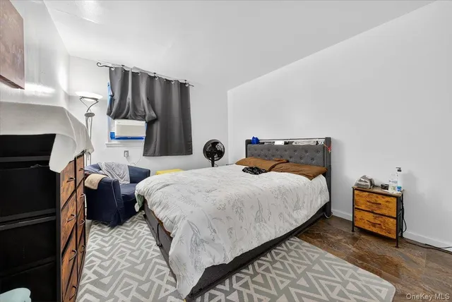 a bedroom with bed and wooden floor