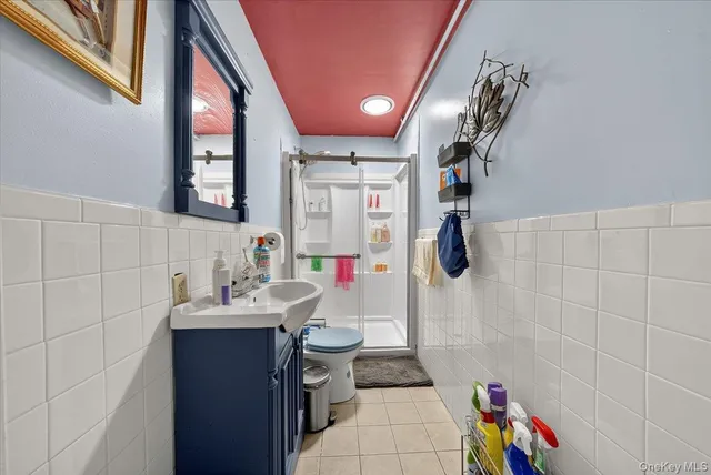 a bathroom with a sink mirror and shower