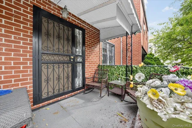 a view of a patio with couches chairs and wooden floor