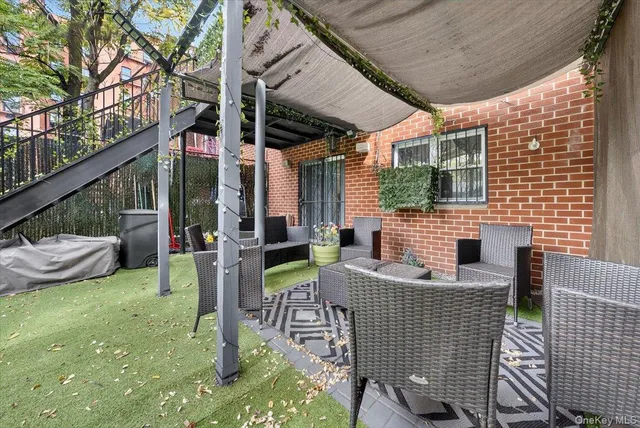 a view of backyard with table and chairs and a large tree